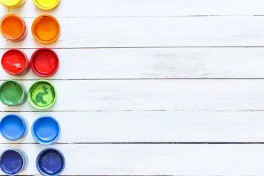 Boyalar ve Beyaz ahşap zemin üzerinde fırçalar