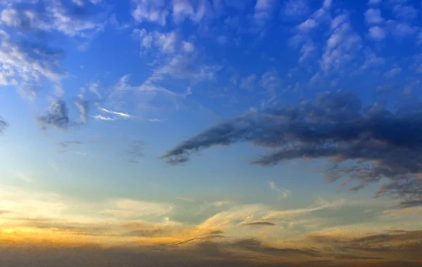 Sunset with sun rays, sky with clouds and sun.