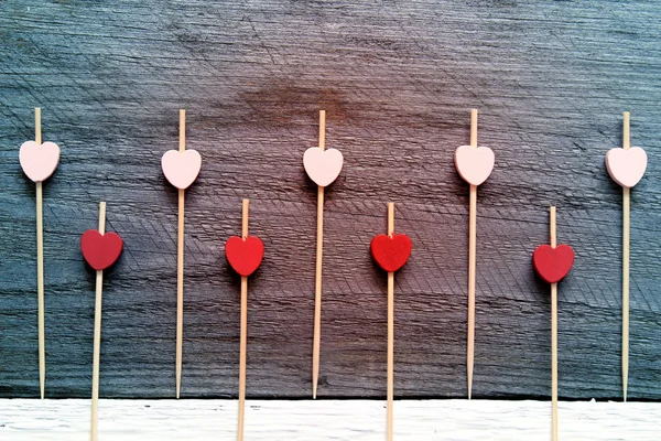 Valentine's day background with hearts. Colorful small wooden hearts on old wooden background. Flat lay, top view, space for text — Stock Photo, Image