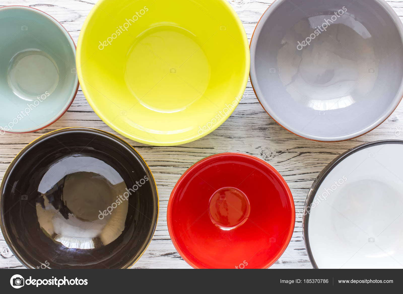 Empty color plates and utensil on wooden table background, top view ... Empty color plates and utensil on wooden table background, top view ...