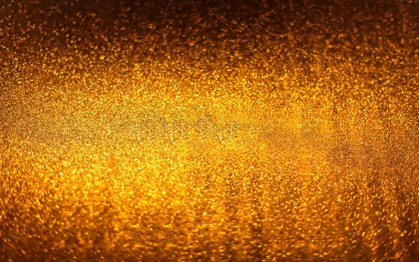 Goldener Hintergrund. abstrakte funkelnde helle Hintergrund mit Bokeh defokussiert goldenen Lichtern. — Stockfoto