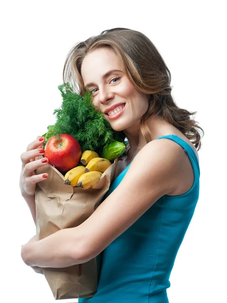 Loira esbelta segurando um saco com legumes e ervas — Fotografia de Stock