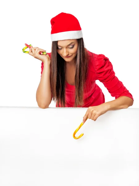 Meisje in een kostuum van de kerst permanent in de buurt van een grote wit bord en — Stockfoto