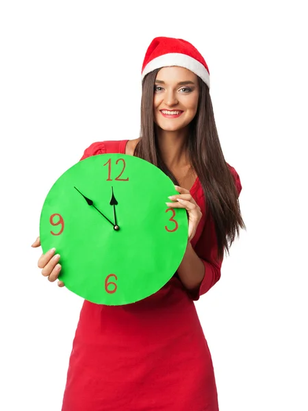 Mooi meisje in kerst kleding houden een groene klok — Stockfoto