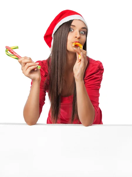 Belle fille dans une robe rouge manger des bonbons canne — Photo
