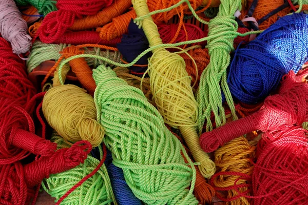 Hanks and coils of multi-colored threads and ropes