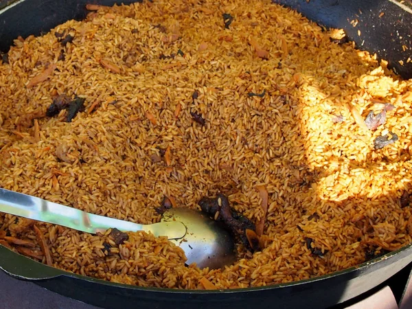 Pilaf with meat in a pig-iron copper