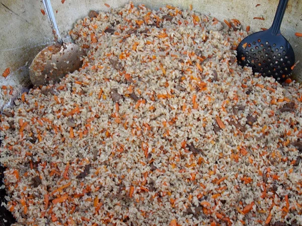 Pilaf with meat in a pig-iron copper