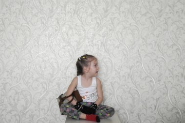 Arka planında süs çiçekleri olan eldivenli bir kız.