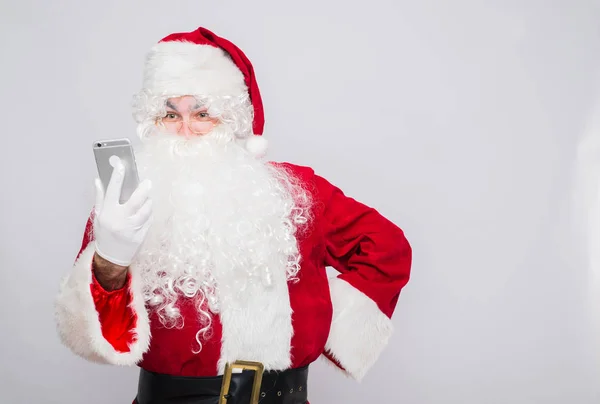 Feliz Santa Claus mirando en el teléfono móvil — Foto de Stock