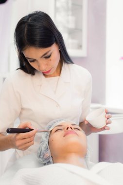 Spa yordamı yüzünde sahip genç güzel kadın