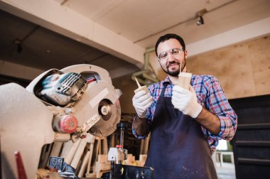 Marangoz bir elektrik buzz üzerinde çalışan bazı kurulları kesme gördüm, koruyucu gözlük takıyor