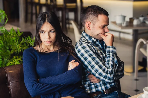 Couple at cafe during lunch. They are taking offense and sitting back — Stock Photo, Image