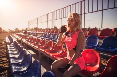 Sonra yoğun Voleybol oyunu, yaz arka plan dinlenme Sahilde oturmuş çekici kadın runner