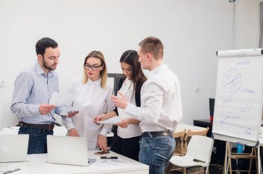 Grup dört farklı erkek ve kadınların Gündelik Giyim ofisinde konuşmak