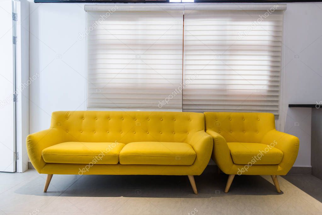 Modern yellow sofa and chair in room interior at home or hotel — Stock