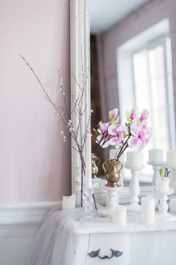 Eski püskü şık ev tasarımı. Bir mum, çiçek bir ayna önünde tabloyla güzel dekorasyon