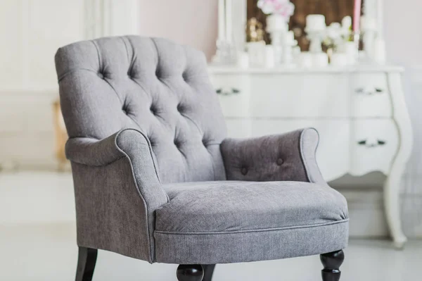 Beige color upholstered chair in living room with flowers — Stock Photo, Image