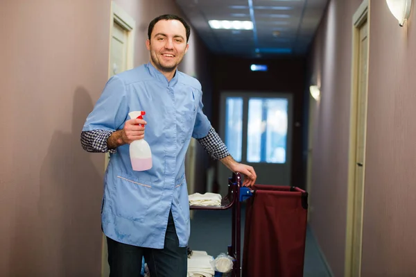 Мужчина чистит гостиницу в синем пальто — стоковое фото