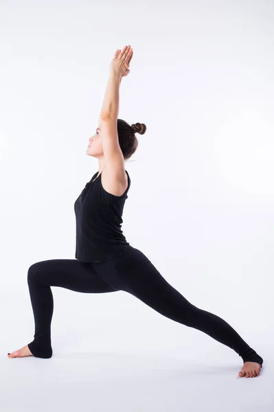 Ung frisk kvinna öva Balancing stick hållning yoga på vit bakgrund. — Stockfoto