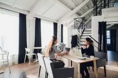 Genç mimar öğrenci tasarım şirketi, coworking Wi-Fi ve dizüstü oturuyor ve çay ile başarılı başlangıç kavramı hakkında konuşmaları sahip iş için röportaj edilmektedir.