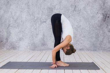 Genç ve formda kadın evde egzersizleri yapıyor.