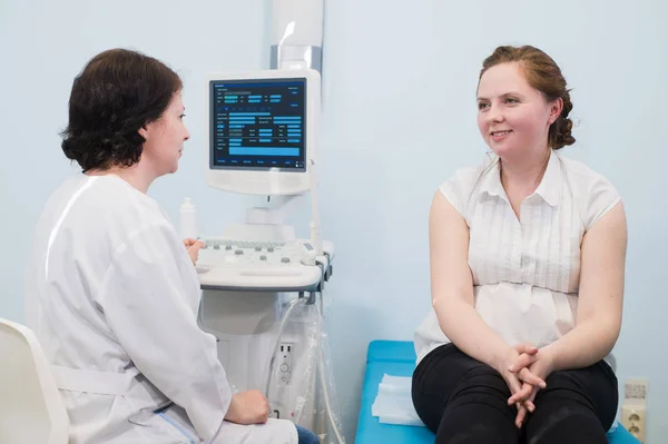 Ginecologista mostrando ultra-som foto para mulher grávida — Fotografia de Stock