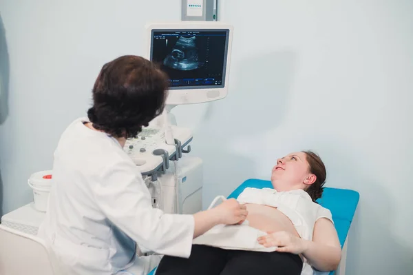 Läkare använder ultraljud och screening mage av gravid kvinna. — Stockfoto
