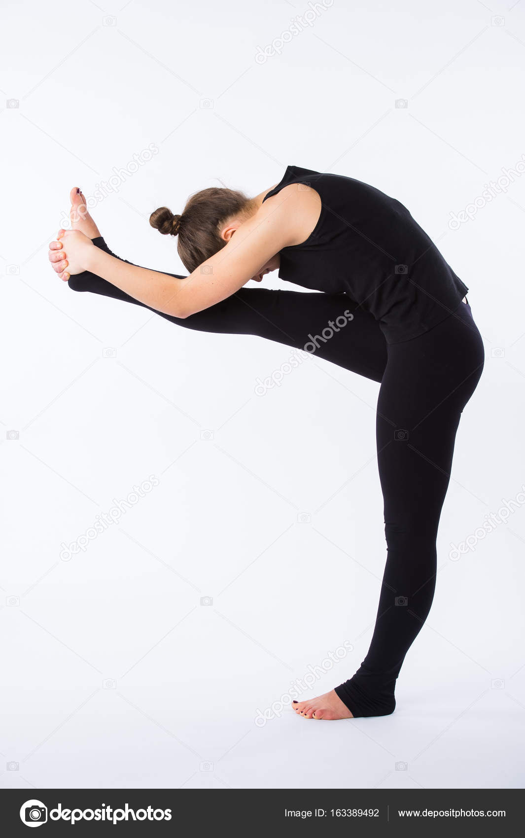 Young healthy woman practicing Balancing stick posture yoga on white  background. Stock Photo by ©romankosolapov 163389492