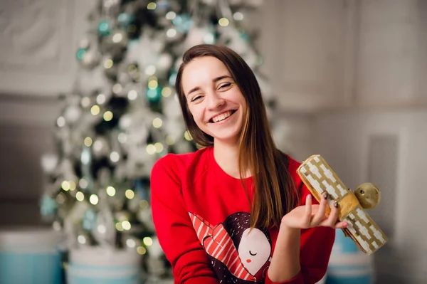 家でクリスマスツリーに座って贈り物と美しい女性の肖像 — ストック写真