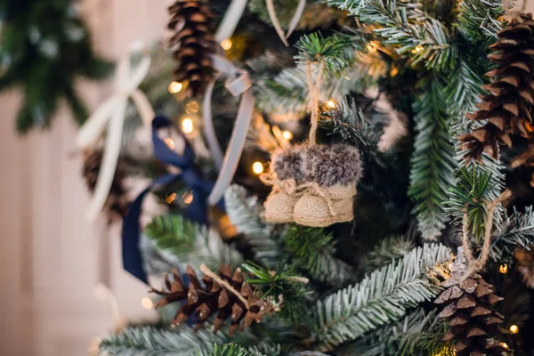 Decorated felt-boots hanging on Christmas-tree