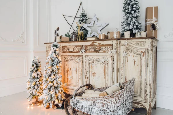Juldekoration på antika vintage gamla commode bröstet av lådor. Handgjorda hantverk gåvor, ljus och ett träd i bakgrunden. — Stockfoto