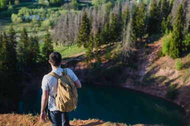 Adam içinde yansıtan gökyüzü göl yukarıda Uçurumdaki ayakta