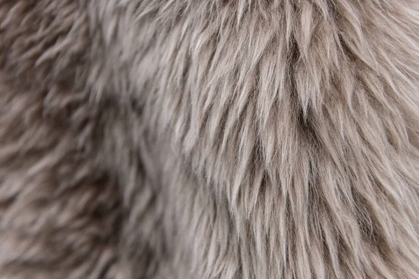 Die Textur des beigen Fells. das Fell ist schön, langes Haar. Grautöne - dunkel und hell. — Stockfoto