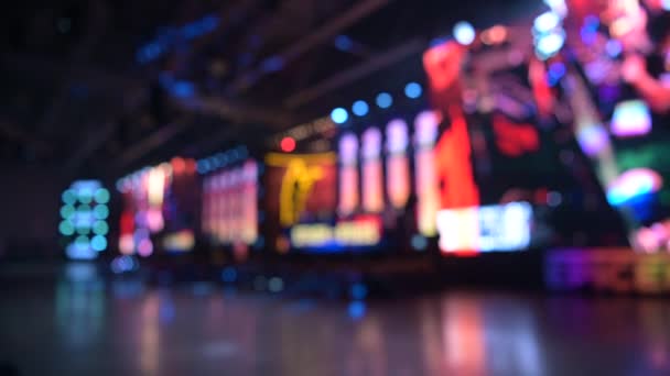 Esports event blurred background. Main stage, lighting, illumination, big screens with game moments. — 图库视频影像