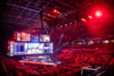 Esport etkinliğinin bulanık arkaplanı - ana sahne mekanı, büyük ekran ve turnuva başlamadan önce ışıklar.