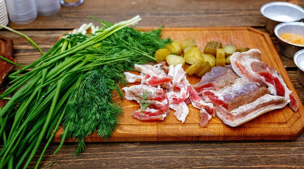 Salted pork lard salo with onion on a wooden board — Stock Image Salted pork lard salo with onion on a wooden board Stock Photo