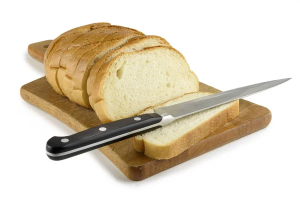 Fresh baked bread on wooden cutting board. Bun slice with knife — Stock Photo, Image