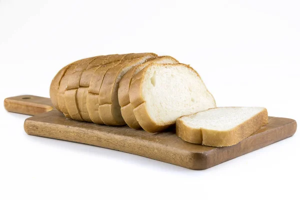 Fresh baked bread on wooden cutting board. Bun slice on isolated — Stock Photo, Image