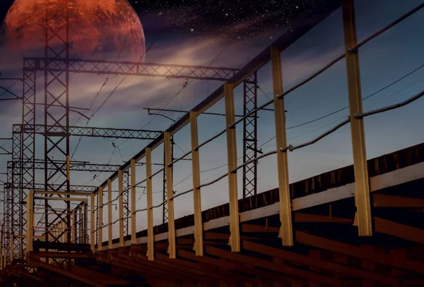Steel construction of bridge   . Future human colony on Mars . Railroad bridge, sunset . Moon sky and clouds .