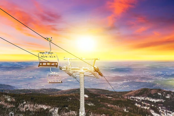 Bright spring sun in the mountains . Panoramic view of an alpine mountainside with ski lift
