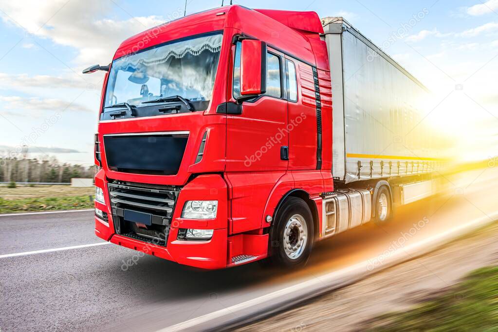 Truck moves on the road at speed, delivery of goods.