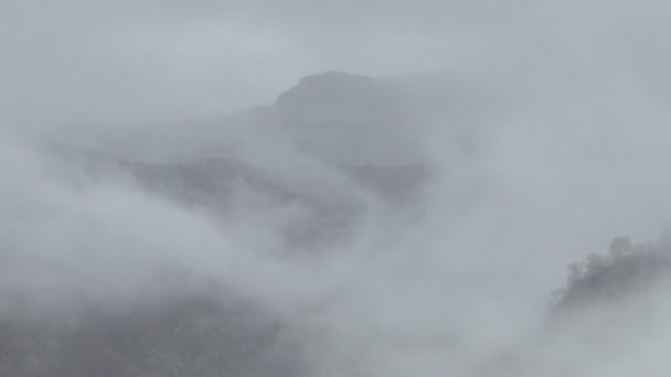 The formation and movements of clouds up to the steep slopes of the  mountains of Central Caucasus peaks. — Stock Video