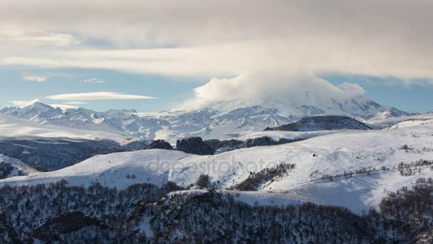 The formation and movement of clouds above the volcano Elbrus in the Caucasus Mountains in winter. — Stock Video