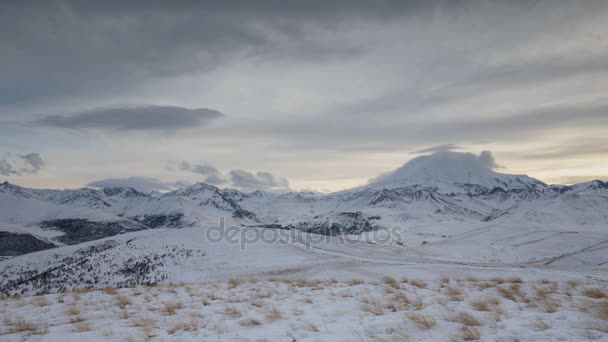 The formation and movement of clouds above the volcano Elbrus in the Caucasus Mountains in winter. — Stock Video