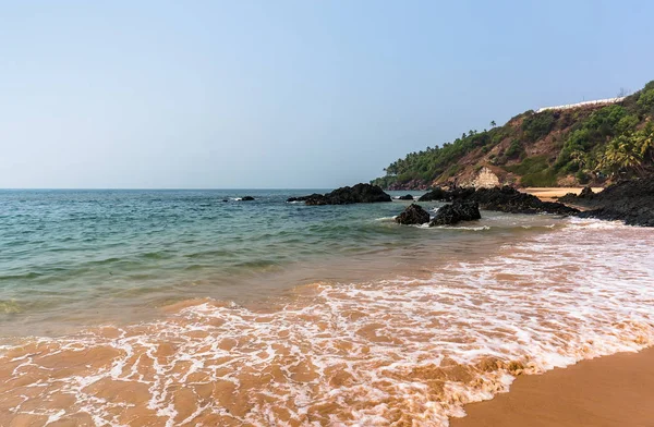 Quiet waves on the Vagator beach Vasco da Gamma. Goa
