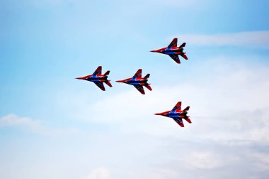 Silhouettes of russian fighter aircrafts in the sky clipart