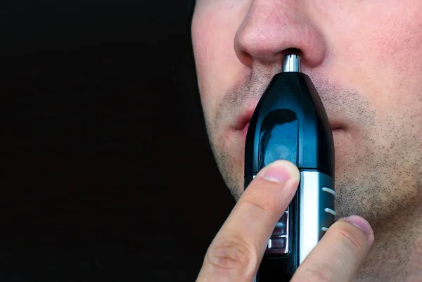 Close-up of man removing hair from his nose — Stock Photo, Image