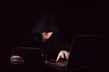 Cyber attack with unrecognizable hooded hacker clipart