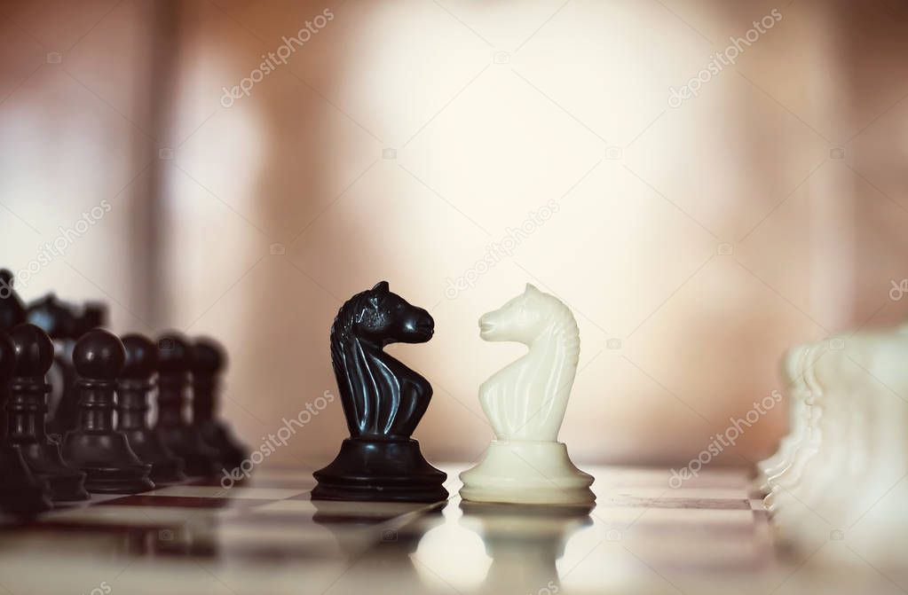 Chess pieces knights facing each other for a standoff